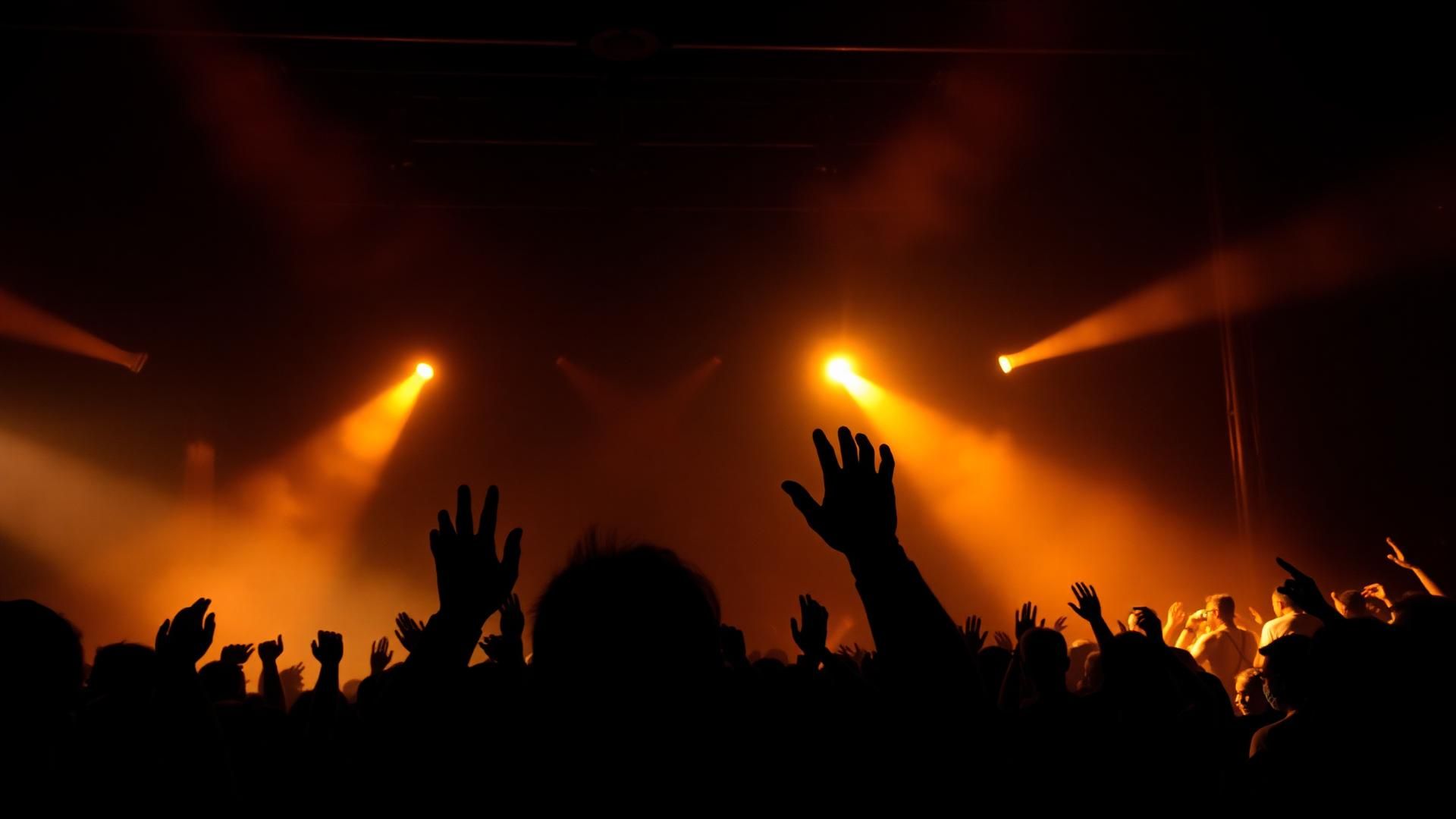 Concert crowd with dramatic stage lighting